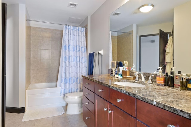 full bathroom with tile patterned flooring, shower / bath combo, vanity, and toilet