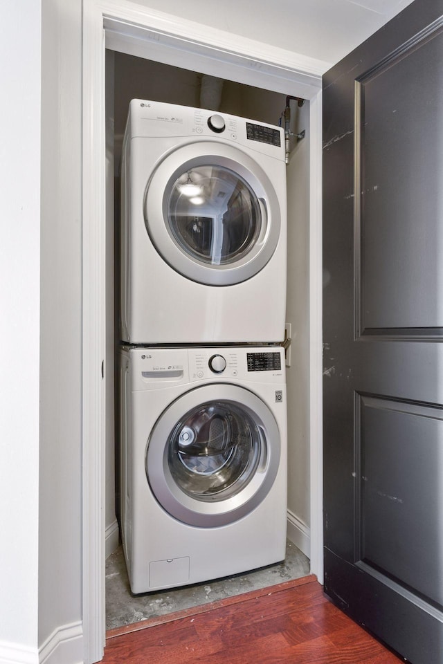 clothes washing area with stacked washer and clothes dryer