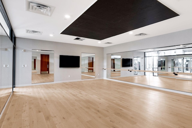 workout area with light wood-type flooring