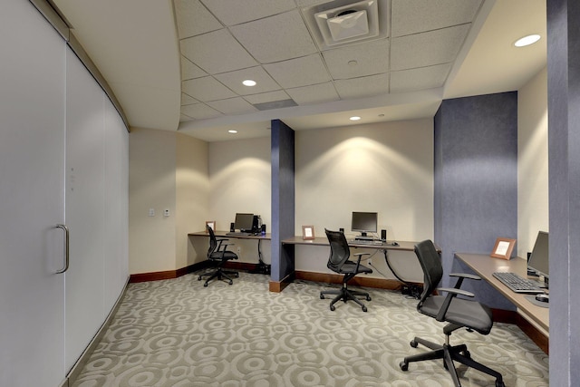 office space featuring a paneled ceiling and light carpet