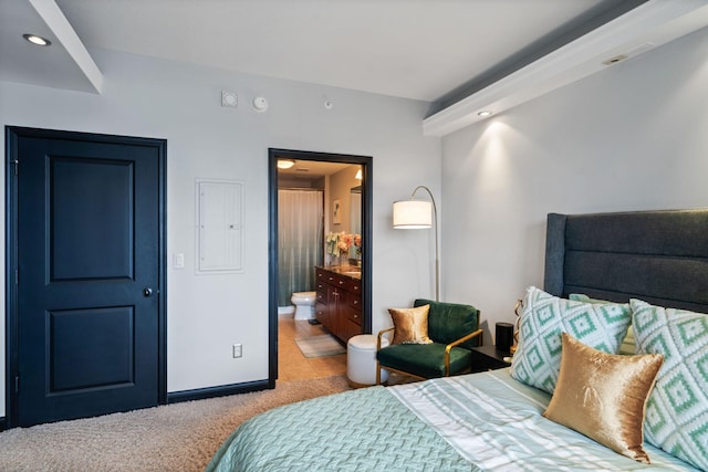 carpeted bedroom featuring connected bathroom