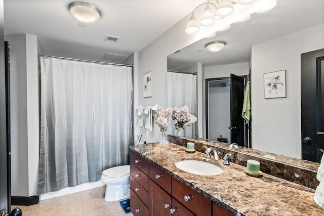 bathroom with vanity, tile patterned floors, and toilet