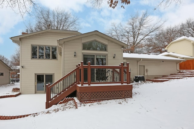 view of snow covered back of property