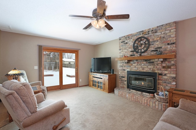 living room with light carpet, a fireplace, and ceiling fan