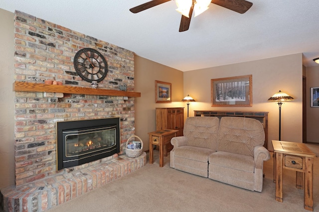 carpeted living room featuring ceiling fan and a fireplace