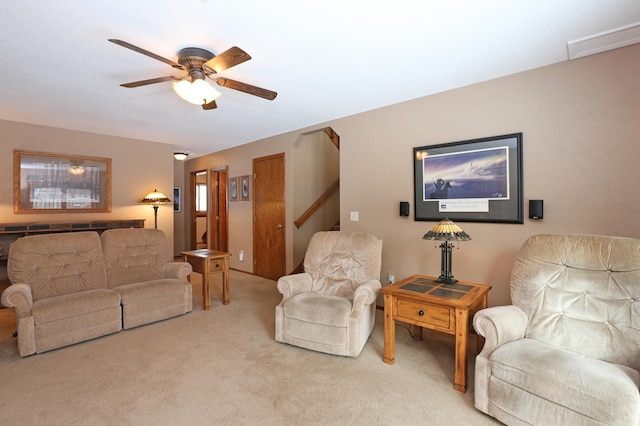 living room with ceiling fan and carpet