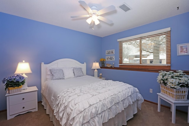 bedroom featuring ceiling fan and carpet