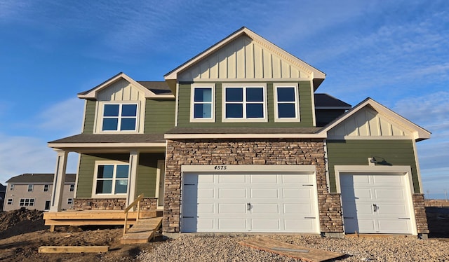 view of front of property featuring a porch, stone siding, and board and batten siding