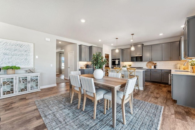 dining room with recessed lighting, baseboards, and dark wood-style flooring