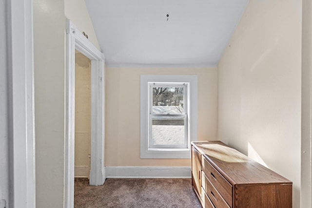 hallway featuring carpet and lofted ceiling