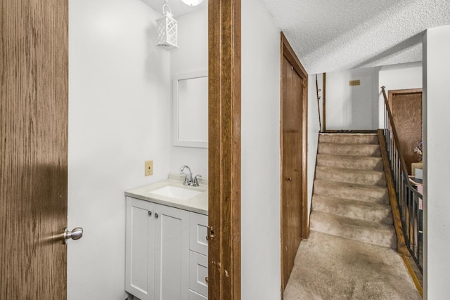 bathroom with a textured ceiling and vanity