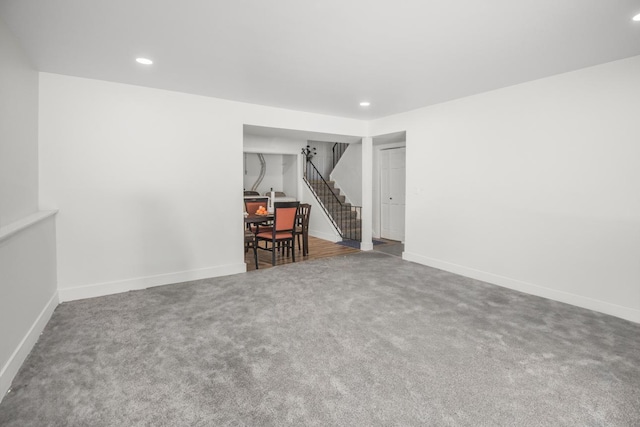 spare room with carpet floors, recessed lighting, stairway, and baseboards