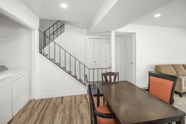 dining room featuring baseboards, washer and clothes dryer, stairway, wood finished floors, and recessed lighting