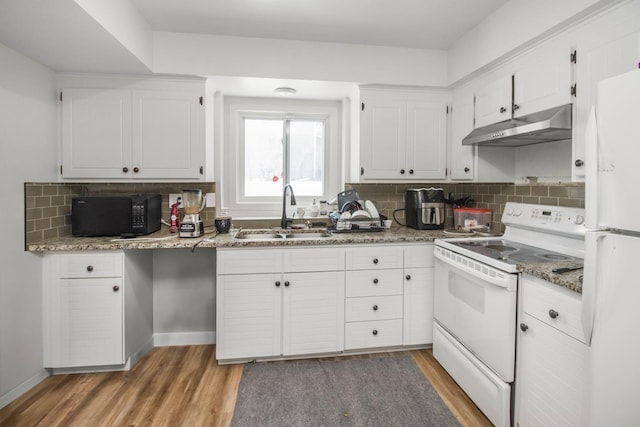 kitchen with white appliances, light stone counters, under cabinet range hood, white cabinetry, and a sink