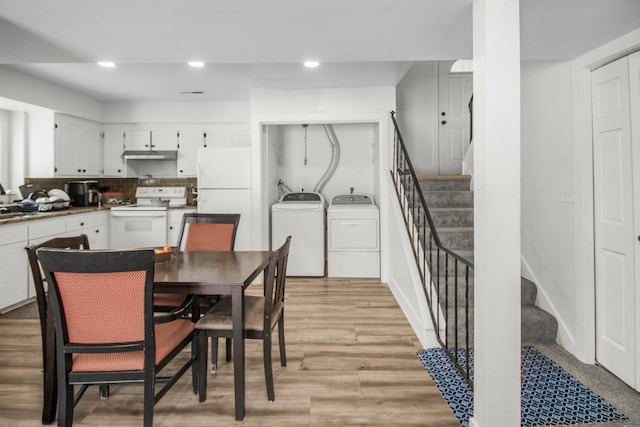 dining space with stairs, light wood-type flooring, washing machine and clothes dryer, and recessed lighting