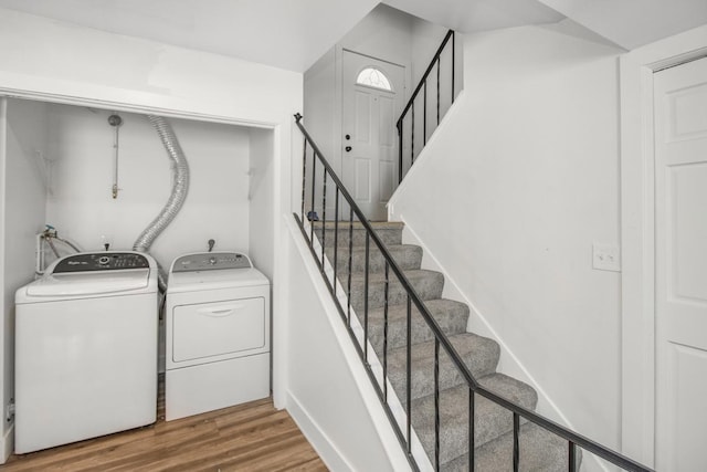 laundry room featuring laundry area, wood finished floors, and independent washer and dryer