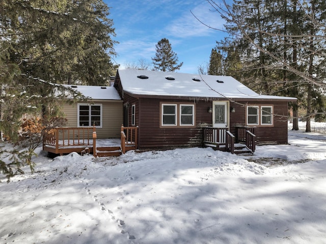 view of snow covered back of property