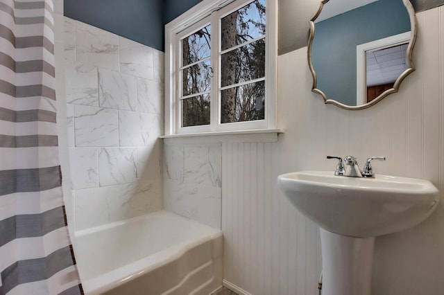 bathroom with sink and shower / bathtub combination with curtain