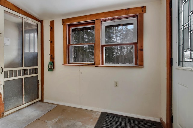 spare room featuring plenty of natural light and concrete floors