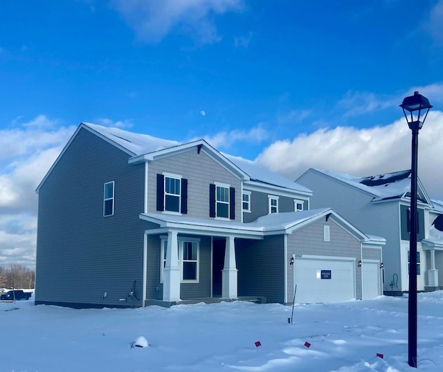 view of front of property with a porch and a garage