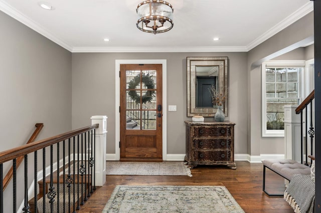 entryway featuring ornamental molding, dark hardwood / wood-style flooring, and a notable chandelier