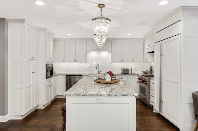 kitchen featuring white cabinetry, a center island, and pendant lighting