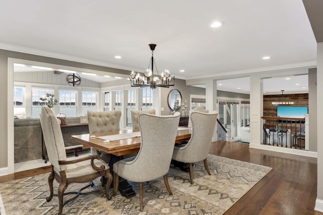 dining room with crown molding, wood-type flooring, and a chandelier