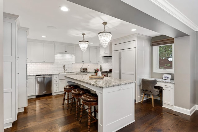 kitchen featuring pendant lighting, sink, stainless steel dishwasher, and white cabinets