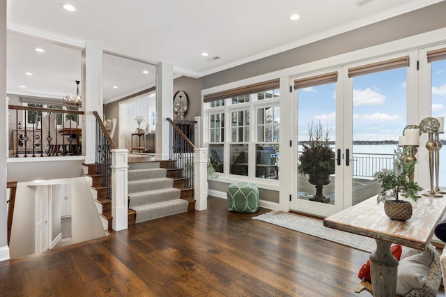 interior space featuring ornamental molding, dark hardwood / wood-style floors, and a water view