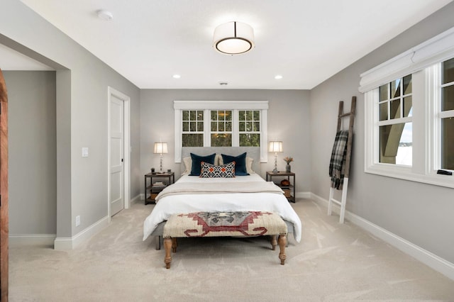 carpeted bedroom featuring multiple windows