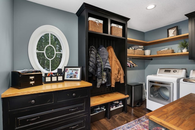 mudroom with dark hardwood / wood-style flooring, a textured ceiling, and washer and clothes dryer