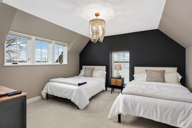 bedroom with lofted ceiling, a chandelier, and carpet