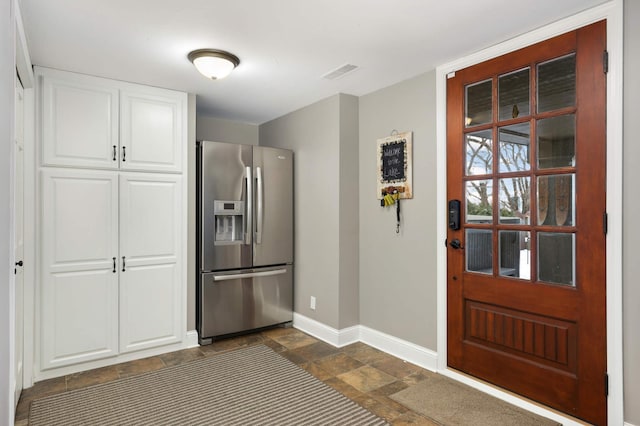 kitchen with white cabinets and stainless steel refrigerator with ice dispenser