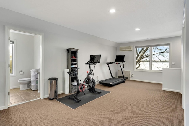 exercise area with light colored carpet and a wall unit AC