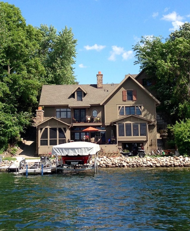 rear view of property featuring a water view