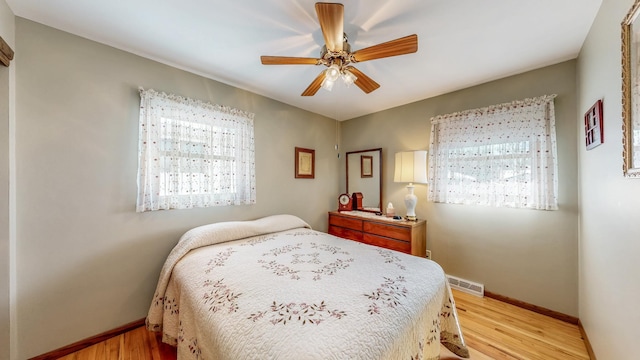 bedroom with ceiling fan and light wood-type flooring