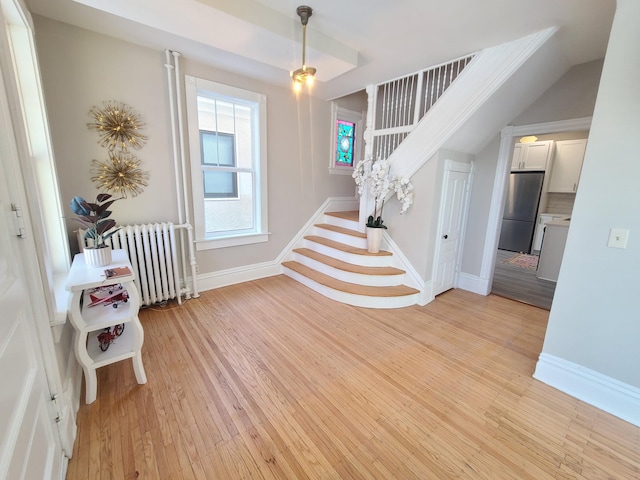 entryway with radiator heating unit and light wood-type flooring