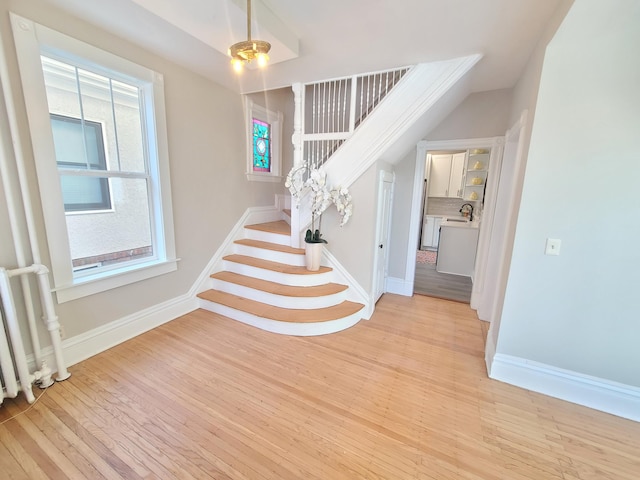 entryway with sink, a wealth of natural light, and light hardwood / wood-style floors