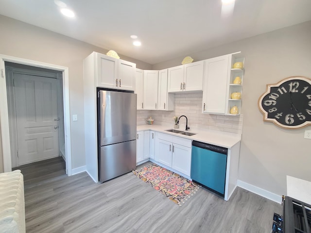 kitchen with white cabinetry, appliances with stainless steel finishes, sink, and decorative backsplash