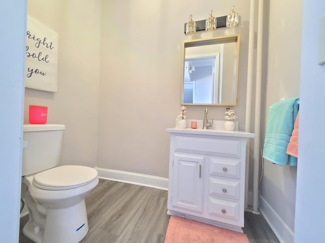 bathroom with vanity, hardwood / wood-style flooring, and toilet