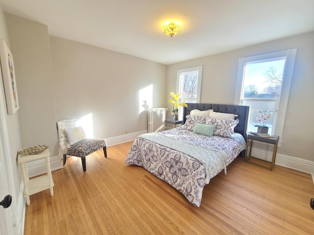 bedroom featuring radiator and light wood-type flooring