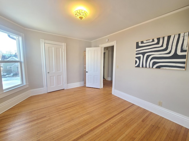 unfurnished bedroom with ornamental molding and light wood-type flooring