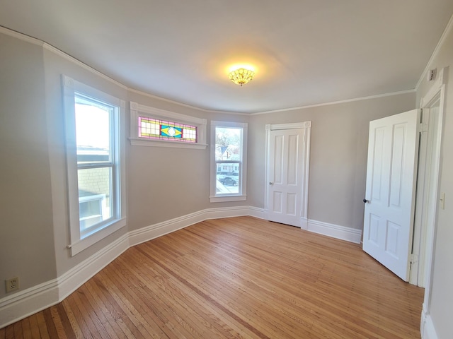 unfurnished bedroom featuring ornamental molding, a closet, and light hardwood / wood-style flooring