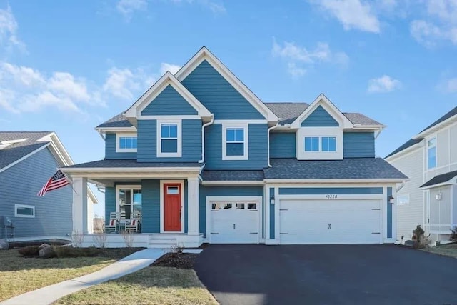 view of front of house featuring a porch and a garage