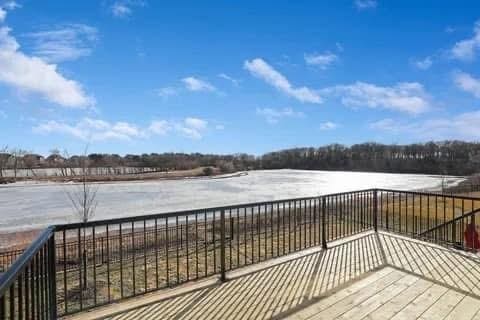 wooden terrace featuring a water view