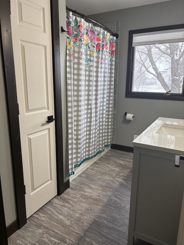 bathroom with vanity and curtained shower