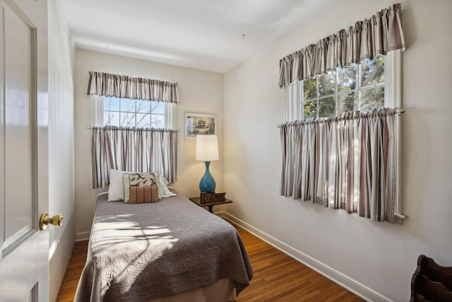 bedroom featuring dark wood-style floors and baseboards