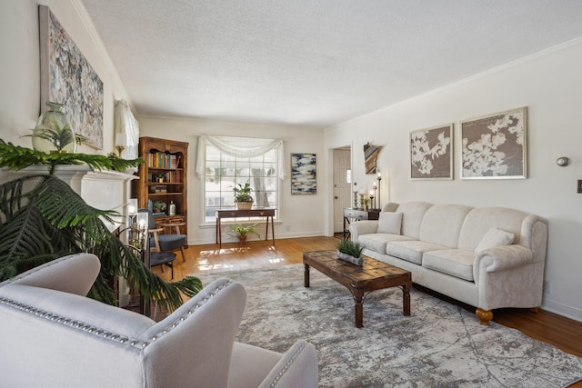 living area with crown molding, a textured ceiling, and wood finished floors