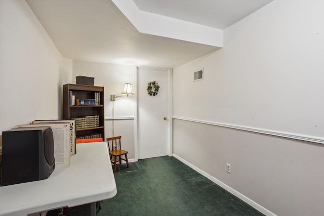 interior space featuring baseboards, visible vents, and dark colored carpet