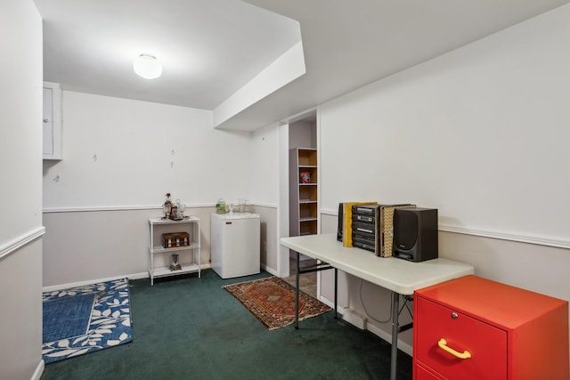 home office featuring baseboards and dark carpet